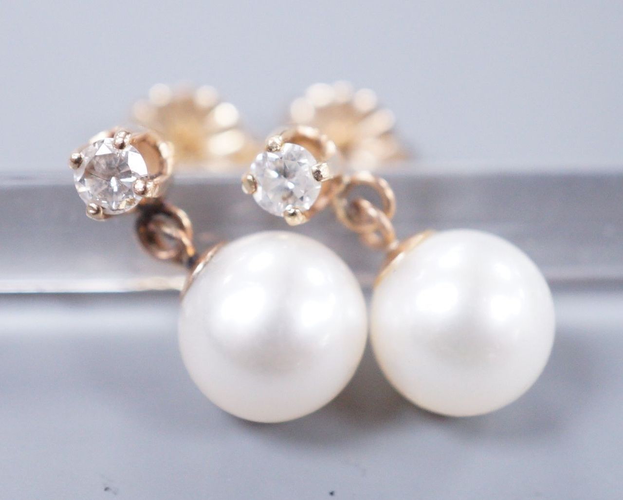 A pair of gold mounted diamond and cultured pearl drop earrings